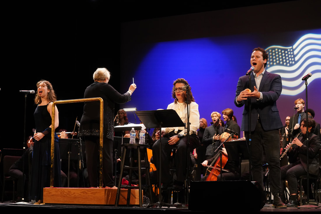 Singers being conducted on stage