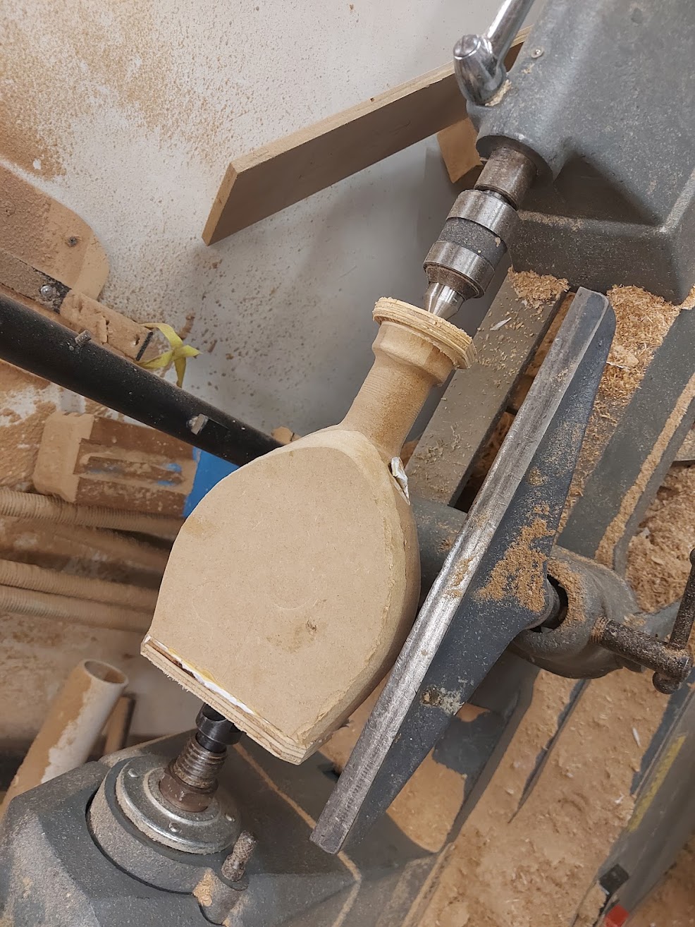 cast of a bottle in a wood lathe