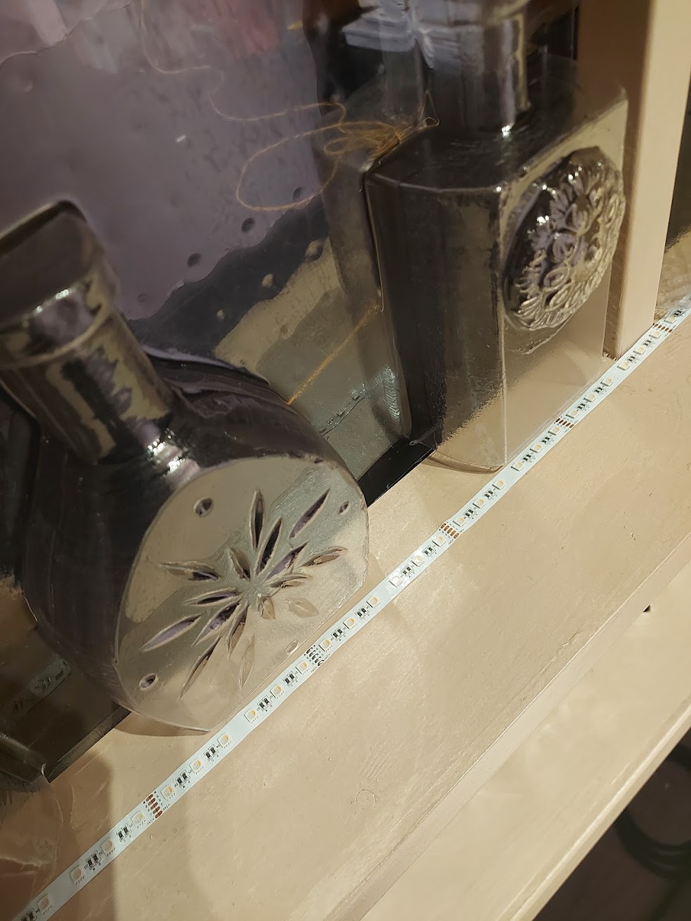 vacuformed bottles shown with the carvings and LED tape