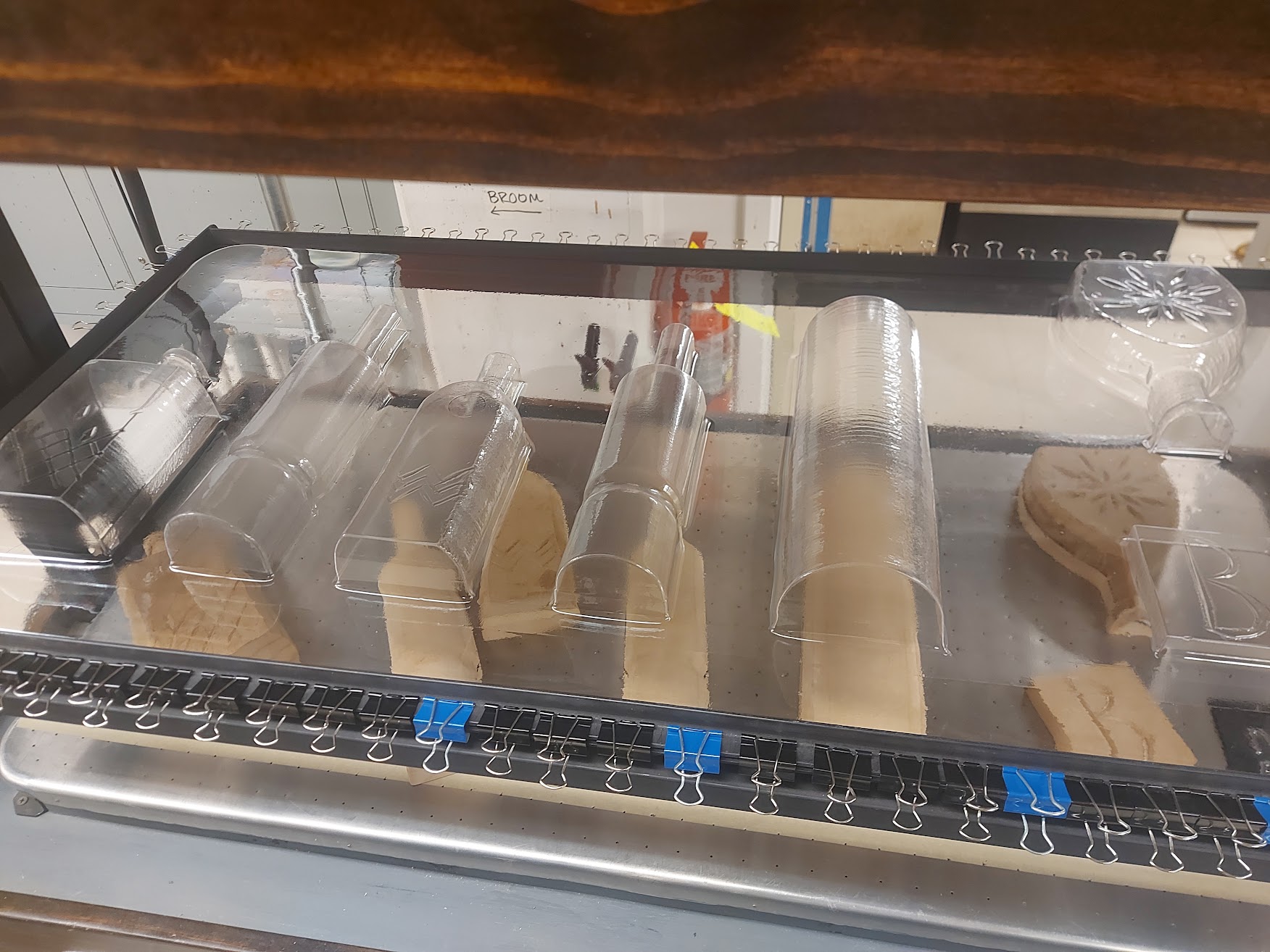 the vacuformed plastic with the bottle shape in the machine