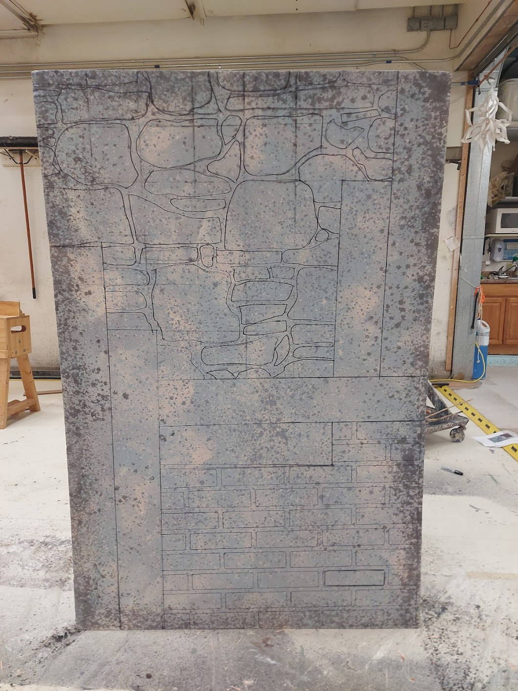 line outline of bricks, stones, and wood planks on a gray background