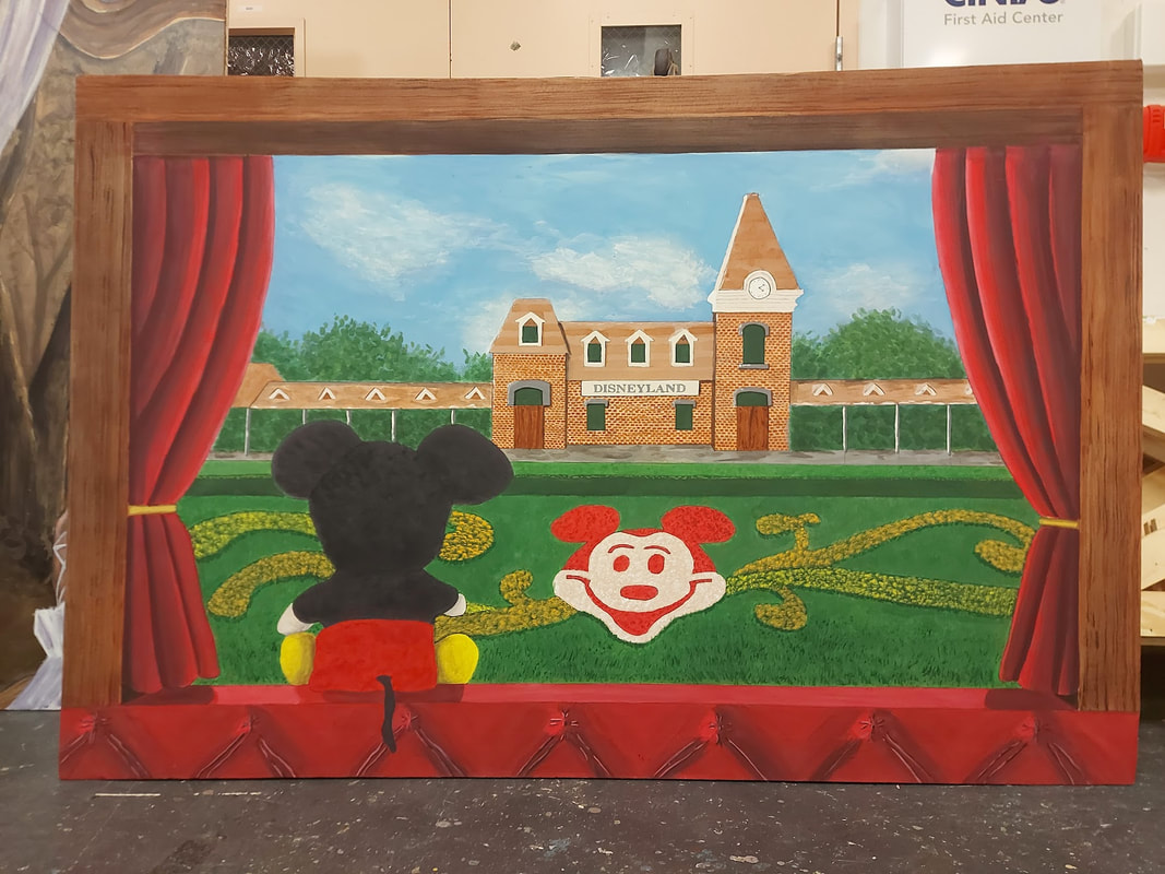 painted image of the Disneyland train station seein through a train window with a Mickey Mouse plush looking out the window